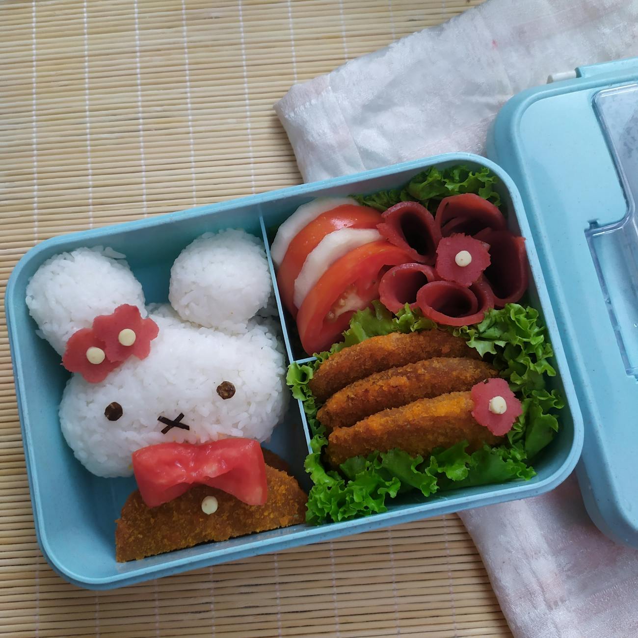 cute bento box with character design rice and vegetables